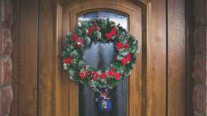 green and red christmas wreath on door